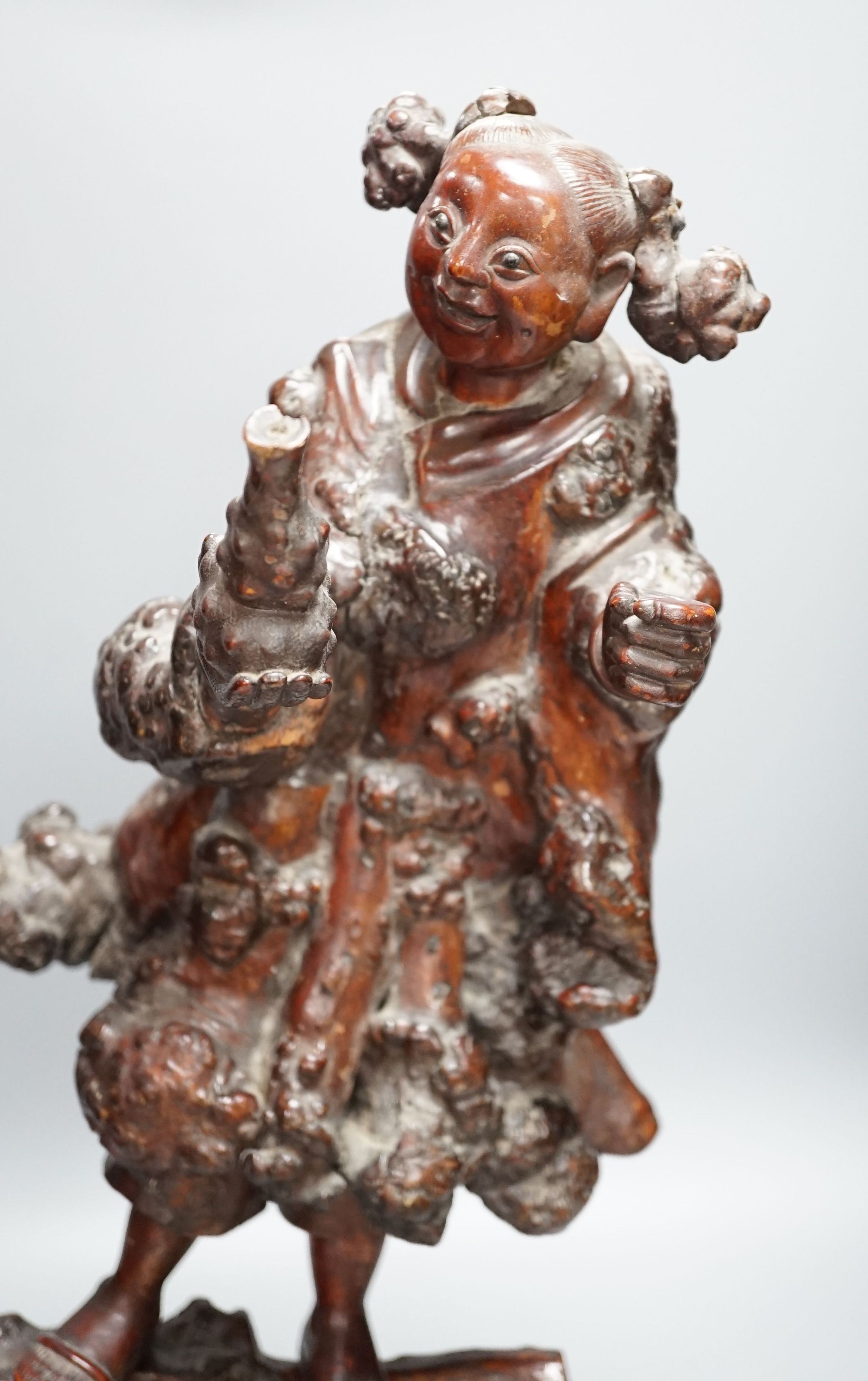 A Chinese root carving of a lady, 57cm
